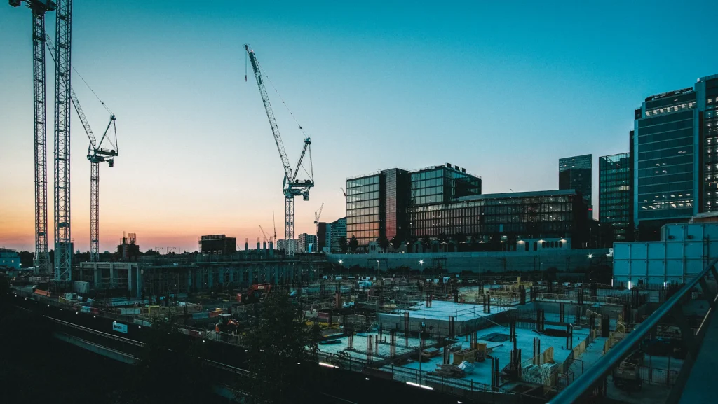 Construction site with cranes at dusk