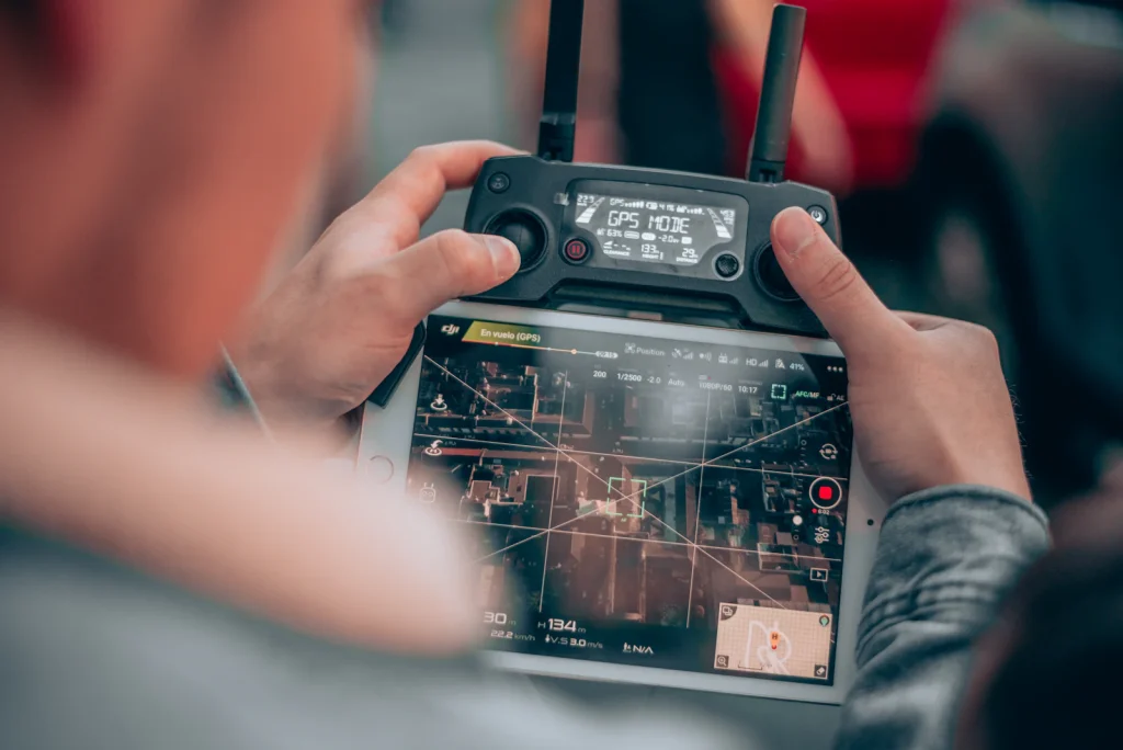 Drone pilot operating a remote controller with live video