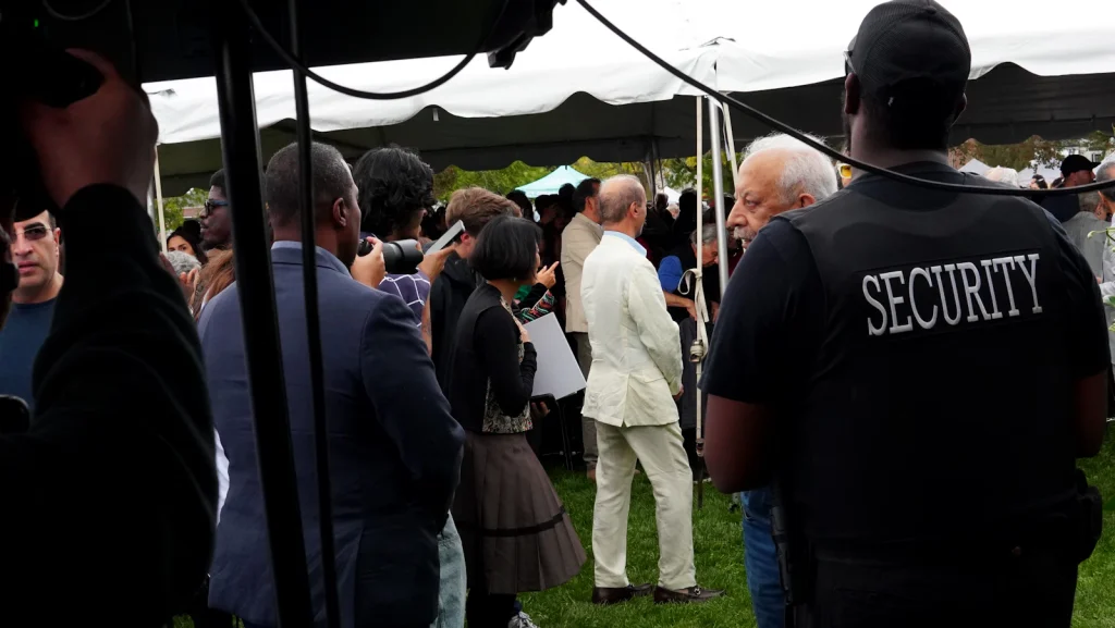 Event security staff overseeing a crowd at an outdoor function